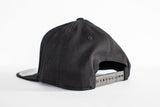Flexfit Solid Black Flat Bill Snapback - Brown Leather Patch